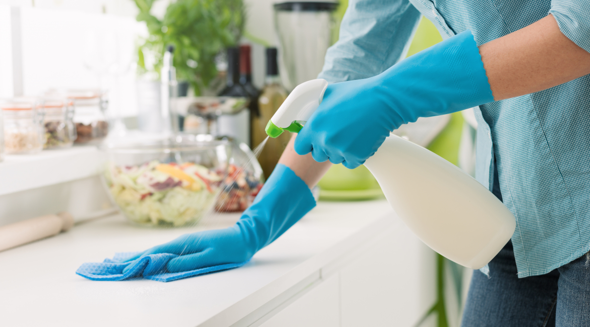 Woman cleaning with a spray detergent